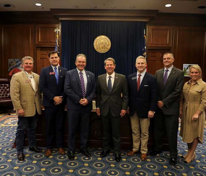 : L-R are Rep. David Knight; Rep. Robert Pruitt; Dr. Christopher Blake, MGA president; Gov. Brian Kemp; Sen. John Kennedy; Adon Clark, dean of MGA’s School of Aviation; and Ember Bishop Bentley, MGA’s chief of staff and government relations officer.